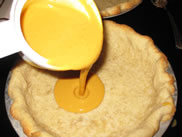 put pumpkin filling into pie crust